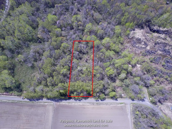 Block 332-127 Aerial View showing farming field located in front of blocks.