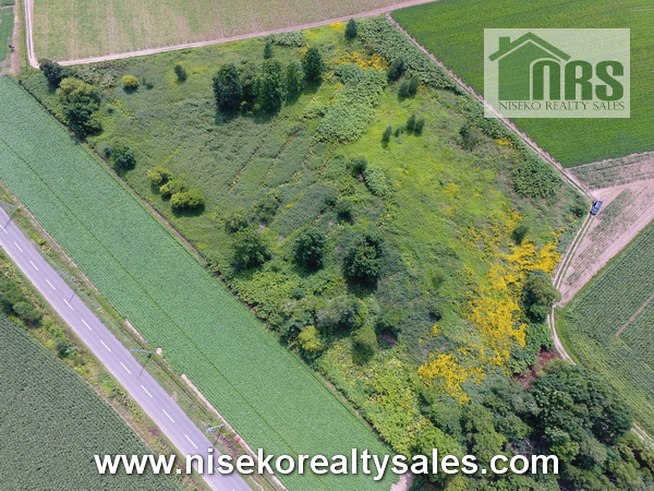 Parcel of land surrounded by farming land.