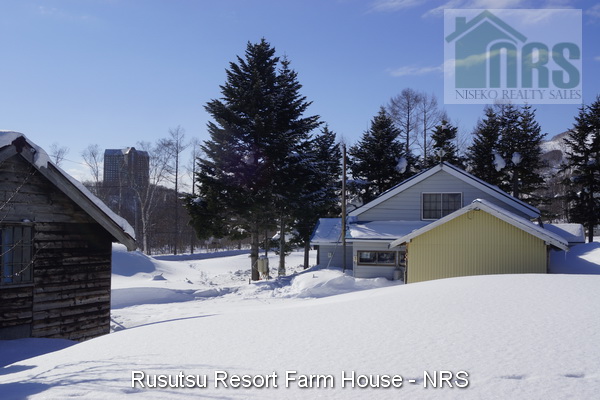 Looking south across block to house with Rusutsu Tower Hotel in background.